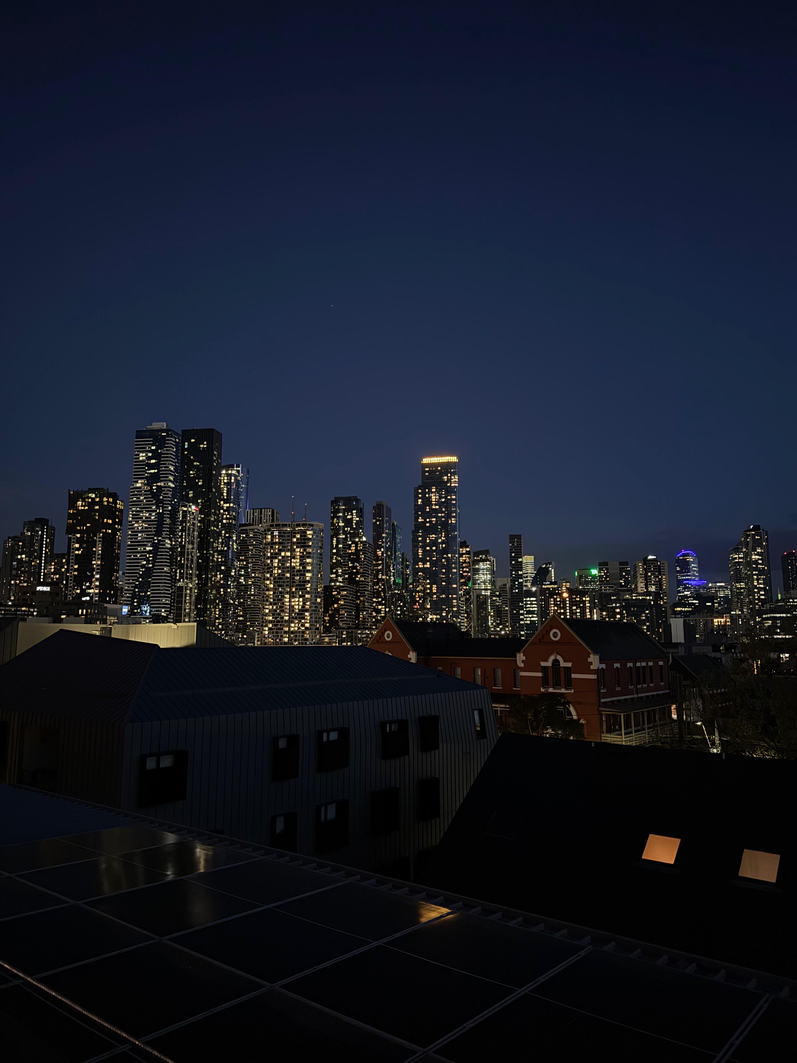 View of Melbourne skyline at night time from a rooftop